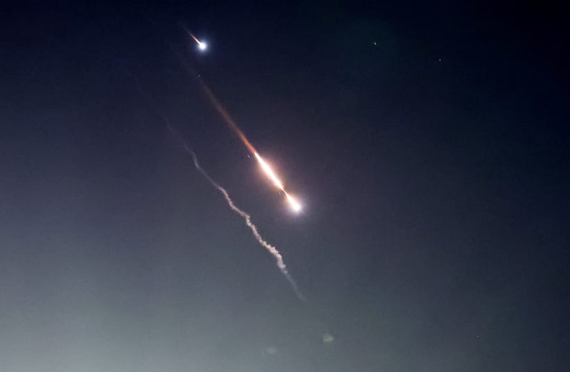  Objects are seen in the sky above Jerusalem after Iran launched drones and missiles towards Israel, in Jerusalem April 14, 2024. (photo credit: RONEN ZVULUN/REUTERS)