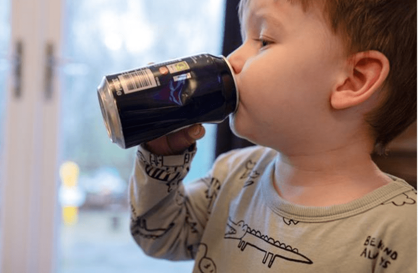  A young child drinking a sugary, fizzy beverage. (photo credit: Swansea University )