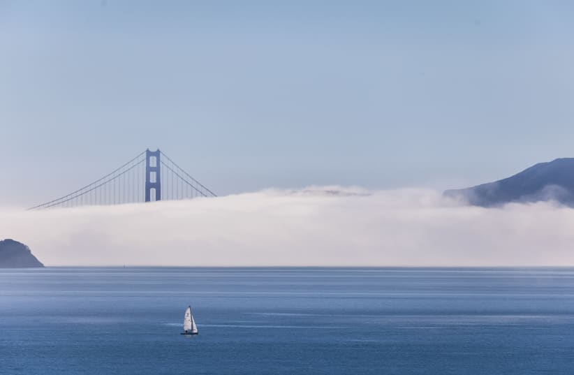 Clouds cover an area of the Golden Gate Bridge in San Francisco, California, US, December 4, 2023. (photo credit: REUTERS/CARLOS BARRIA)