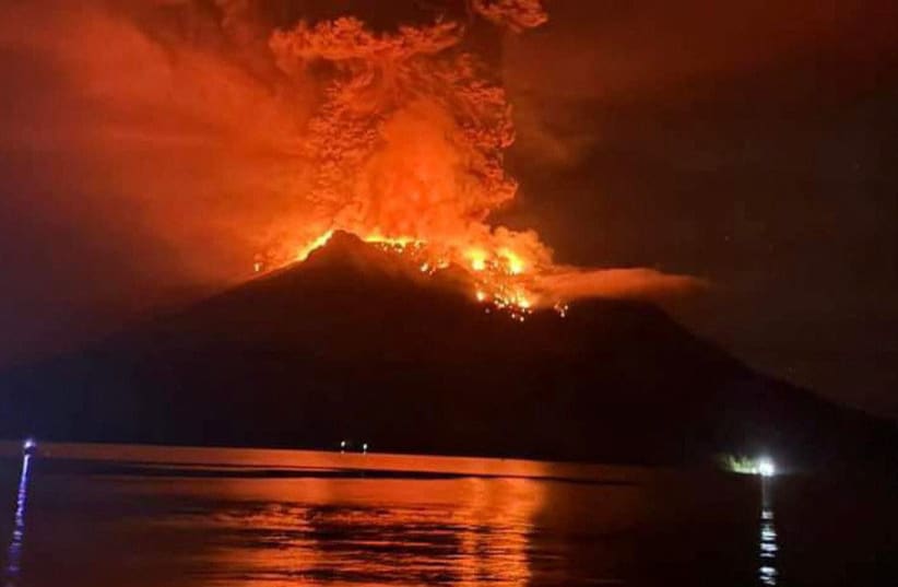  Hot lava flows from Mount Ruang volcano during an eruption in Sitaro, North Sulawesi province, Indonesia, April 17, 2024.  (photo credit: Antara Foto/HO/BPBD Kab Sitaro/via REUTERS)