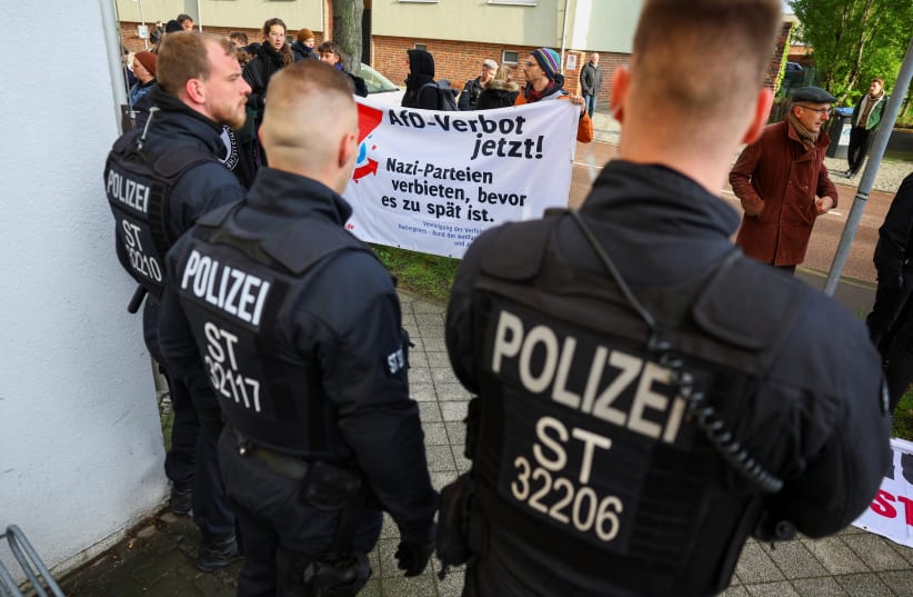  Members of the police force stand guard as demonstrators protest against German far-right politician of the Alternative for Germany (AfD) Bjoern Hoecke on the day of his trial over the alleged use of Nazi vocabulary during a speech in May 2021. April 18, 2024.  (photo credit: REUTERS/Fabrizio Bensch/Pool)