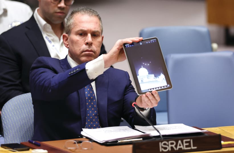  ISRAELI AMBASSADOR to the UN Gilad Erdan shows a video of Iranian drones and missiles heading toward Israel, at a UN Security Council meeting in New York City, April 14. (photo credit: Charly Triballeau/AFP via Getty Images)