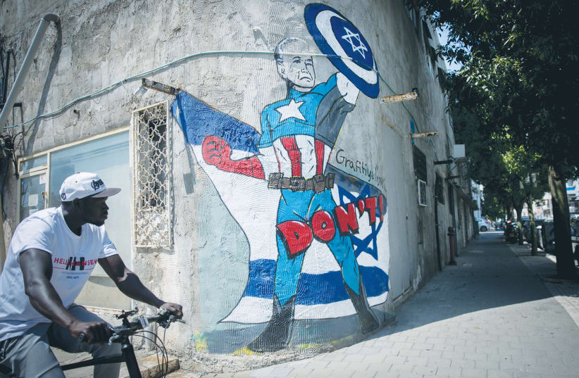 A MURAL in Tel Aviv depicts US President Joe Biden as a superhero defending Israel against the Iranian attack. On the strategic level, Israel suffered a whopping loss as Iran pierced American and Israeli deterrence frameworks with apparent impunity, the writer maintains. (photo credit: MIRIAM ALSTER/FLASH90)