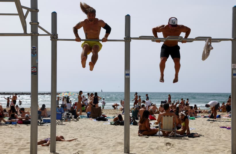  People exercise at the beach in Tel Aviv, Israel April 20, 2024. (photo credit: REUTERS/HANNAH MCKAY)