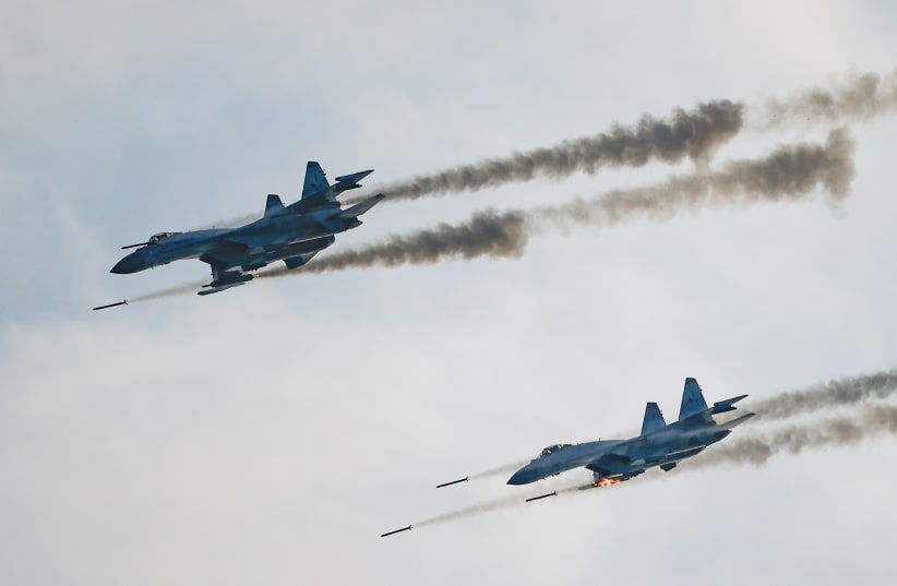  Russian Sukhoi Su-35 jet fighters fire missiles during the Aviadarts competition, as part of the International Army Games 2021, at the Dubrovichi range outside Ryazan, Russia August 27, 2021. (photo credit: MAXIM SHEMETOV/REUTERS)