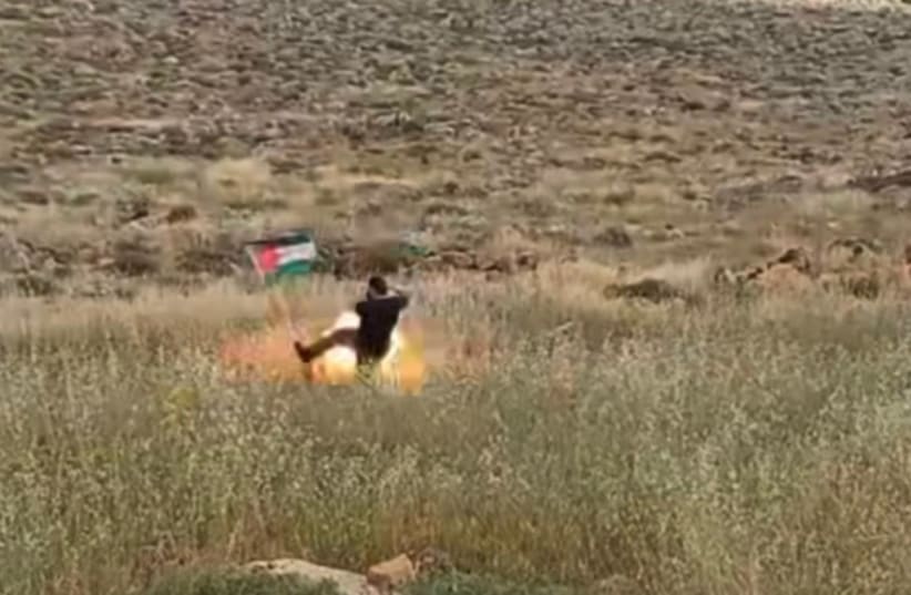  Footage of an Israeli going to take down a Palestinian flag before the explosive device went off in Kochav Hashahar, in the West Bank. April 21, 2024. (photo credit: Screenshot/Instagram)