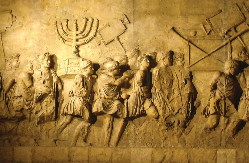  A depiction of the Roman triumph celebrating the conquest of Jerusalem on the Arch of Titus in Rome, featuring the menorah and other items taken from the Second Temple.  (photo credit: ANU MUSEUM/WIKIPEDIA)