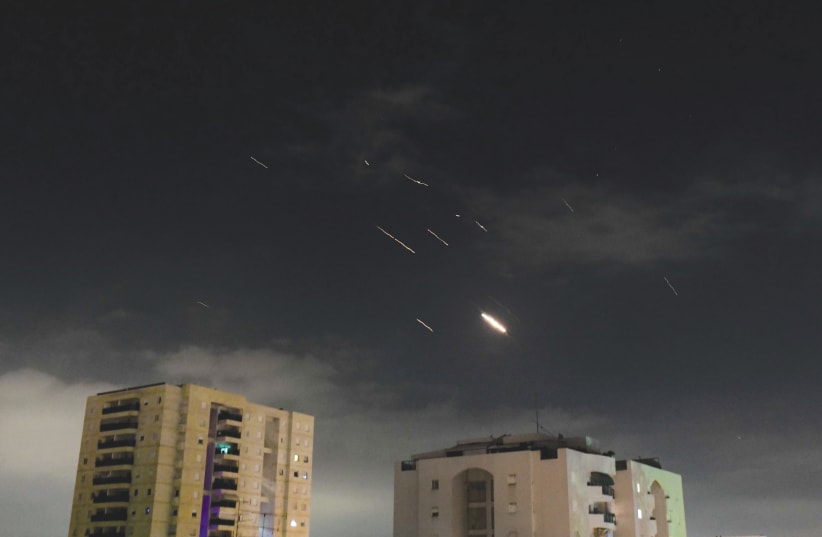  INCOMING AERIAL threats are intercepted in Israeli skies early Sunday morning. (photo credit: TOMER NEUBERG/FLASH90)