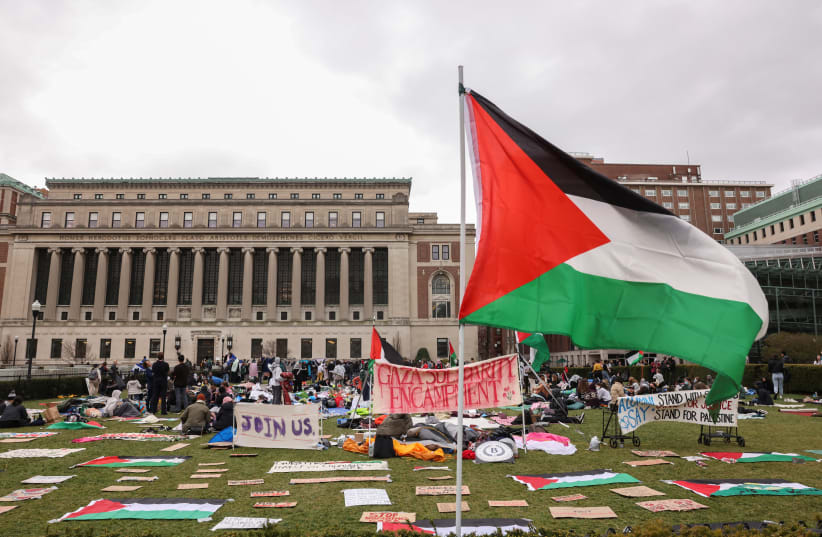  Demonstrators sit in an encampment as they protest in solidarity with Pro-Palestinian organizers on the Columbia University campus, amid the ongoing conflict between Israel and Hamas, in New York City, US. April 19, 2024. (photo credit: CAITLIN OCHS/REUTERS)