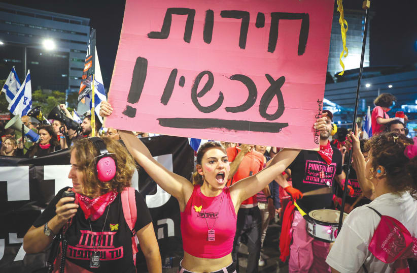  A WOMAN holds a sign that reads ‘Freedom now!’ at a demonstration in Tel Aviv on Saturday night. More is unknown than is known, the writer laments. (photo credit: ITAI RON/FLASH90)