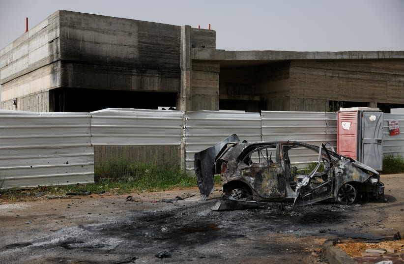  A destroyed vehicle stands outside a damaged community center, the day after Hezbollah launched missiles and drones at the Bedouin village of Arab al-Aramshe, amid ongoing cross-border hostilities between Hezbollah and Israel, in northern Israel April 18, 2024. (photo credit: Hannah McKay/Reuters)