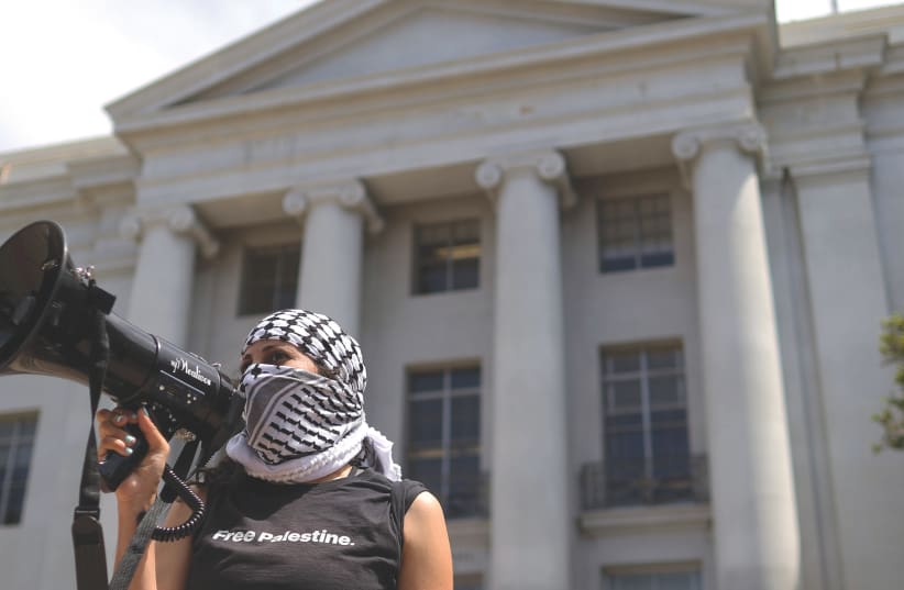  A PRO-PALESTINIAN protester uses a bullhorn during a demonstration on the UC Berkeley campus on Monday. (photo credit: JUSTIN SULLIVAN/GETTY IMAGES)