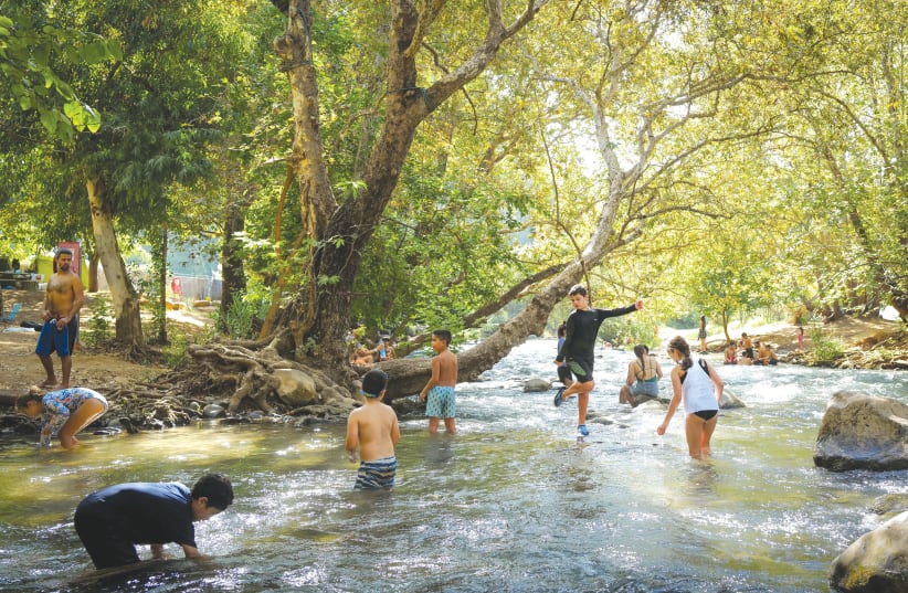 FAMILIES VACATION at the Hasbani River in the Upper Galilee last year. Importantly, 21% of families in the North rely on tourism for their income, the writer notes. (photo credit: MICHAEL GILADI/FLASH90)