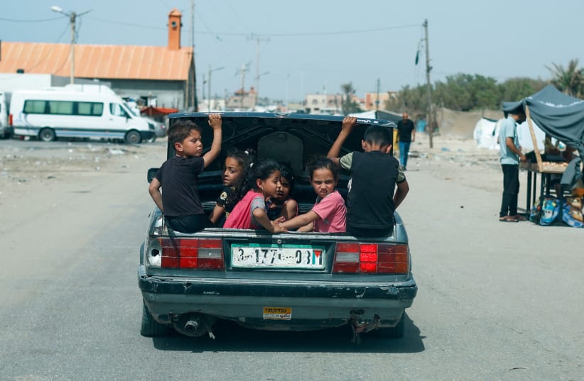  Children sit in a car trunk, amid the ongoing conflict between Israel and Hamas, in Rafah, in the southern Gaza Strip, April 24, 2024. (photo credit: REUTERS/MOHAMMED SALEM)