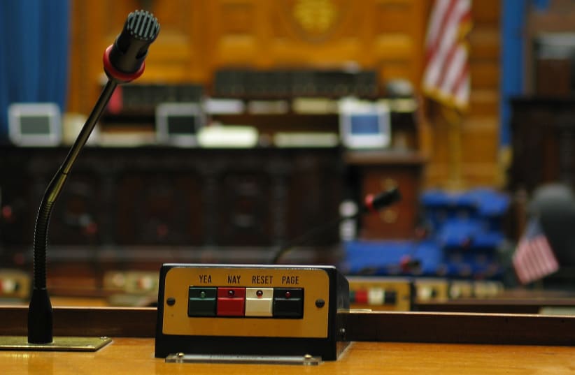  Representatives' desk with microphone and voting buttons (yea/nay) (photo credit: DANIEL SCHWEIN, CREATIVE COMMONS https://creativecommons.org/licenses/by-sa/2.5)