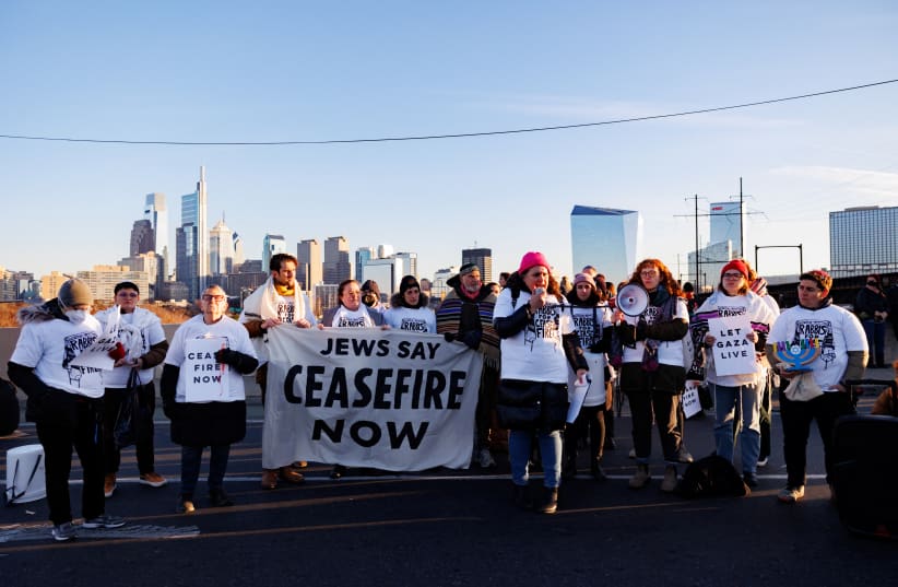  Protesters from the national group Jewish Voice for Peace call for a ceasefire in the Israel-Hamas war during rallies across the U.S. marking the 8th night of Hanukkah as they block a highway in Philadelphia, Pennsylvania, US, December 14, 2023. (photo credit: REUTERS/HANNAH BEIER)