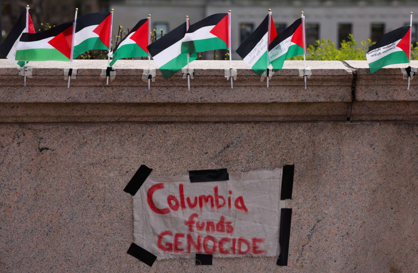  A sign is seen at Columbia University near a protest encampment on the main campus in support of Palestinians, during the ongoing conflict between Israel and the Palestinian Islamist group Hamas, in New York City, U.S., April 27, 2024. (photo credit:  REUTERS/Caitlin Ochs)