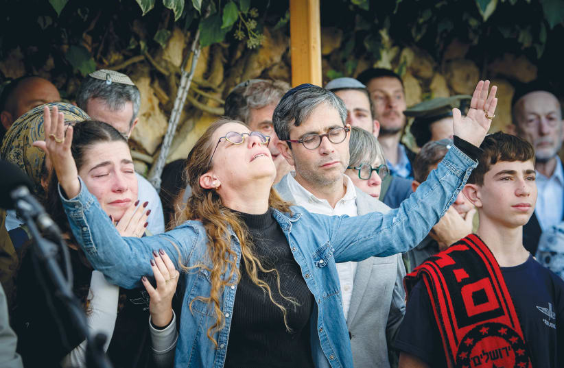  SARIT ZUSSMAN and other family members and friends mourn the death of Sgt. First Class (res.) Ben Zussman at his funeral at the Mount Herzl Military Cemetery in Jerusalem in December, after he was killed in the IDF’s Gaza ground operation. (photo credit: Arie Leib Abrams/Flash90)