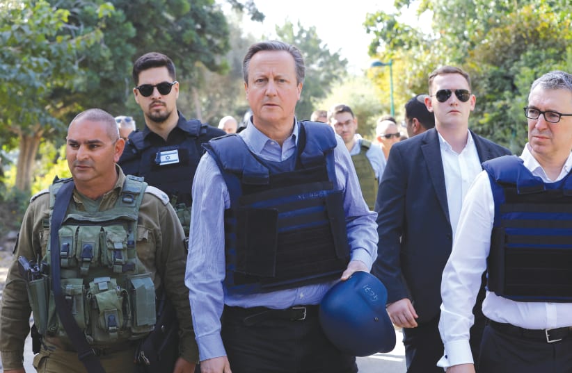  British Foreign Secretary David Cameron visits Kibbutz Be’eri in November. So far, the new British Middle East policy pays off, building bridges of trust with the Israeli side, the writer maintains.  (photo credit: Alexander Ermochenko/Reuters)