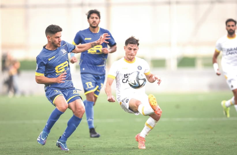  MACCABI TEL AVIV’S Gaby Kanichowsky dribbles during the yellow-and-blue’s 3-2 road win this week at Maccabi Bnei Reineh in Israel Premier League action. (photo credit: MACCABI TEL AVIV/COURTESY)