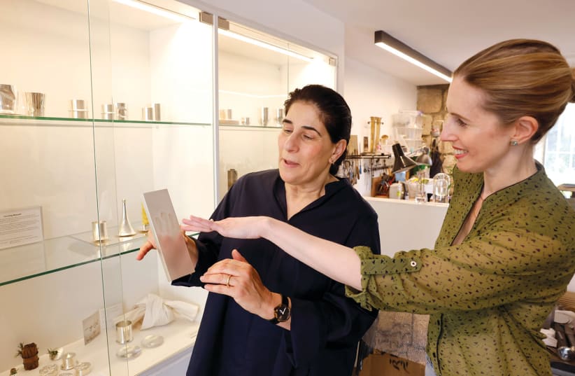  Artist Sari Srulovitch (L) and ‘In Jerusalem’ Editor Erica Schachne get hands-on with the ‘Touching’ Mezuzah, in her Hutzot Hayotzer studio. Note the ‘Shin’ three-finger impressions offer a tactile experience. (photo credit: MARC ISRAEL SELLEM)