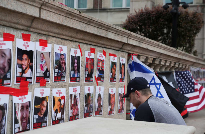  CONTEMPLATIVE MOMENTS on campus in front of hostages, near the pro-Palestinian encampment at Columbia University, New York City, April 24.  (photo credit: REUTERS/David Dee Delgado)