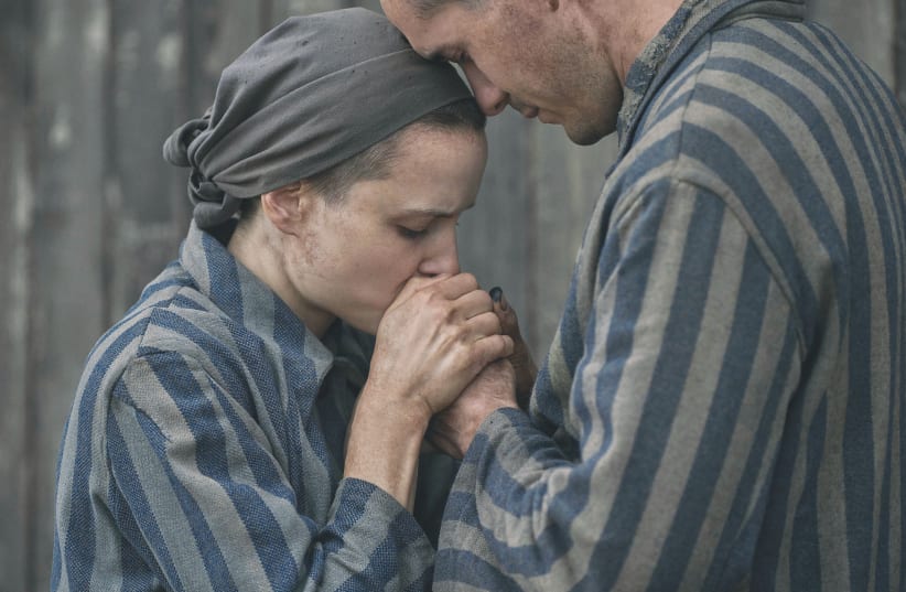  JONAH HAUER-KING as Lali Sokolov and Anna Próchniak as Gita Furman in ‘The Tattooist of Auschwitz.’ (photo credit: Martin Mlaka/Peacock)