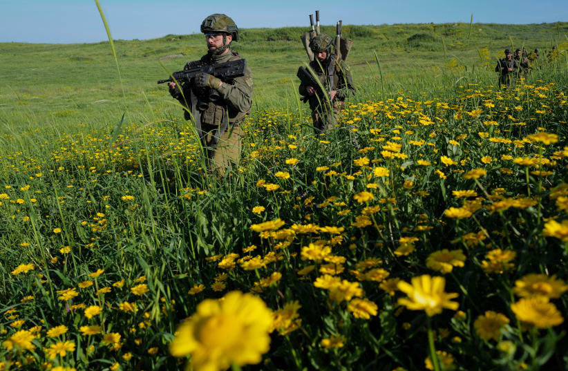  Amidst tension with Syria, IDF Reserve infantrymen take part in a military maneuver of their battalion in Golan Heights, on April 1, 2024.  (photo credit: MICHAEL GILADI/FLASH90)
