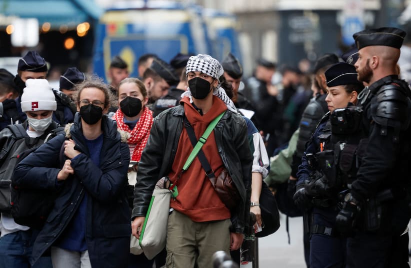  Protesters in support of Palestinians in Gaza are escorted away by police forces during the evacuation of the Sciences Po University, amid the ongoing conflict between Israel and the Palestinian Islamist group Hamas, in Paris, France, May 3, 2024. (photo credit: REUTERS/BENOIT TESSIER)