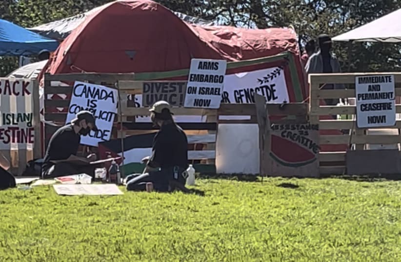  People sitting on the grass infront of UVIC pro-Palestine protest encampment. 4/5/2024 (photo credit: MICHAEL STARR)