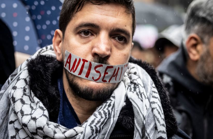  A pro-Palestinian protester wearing a piece of tape over his mouth that reads, "antisemite." (photo credit: dpa/picture alliance via Getty Images)