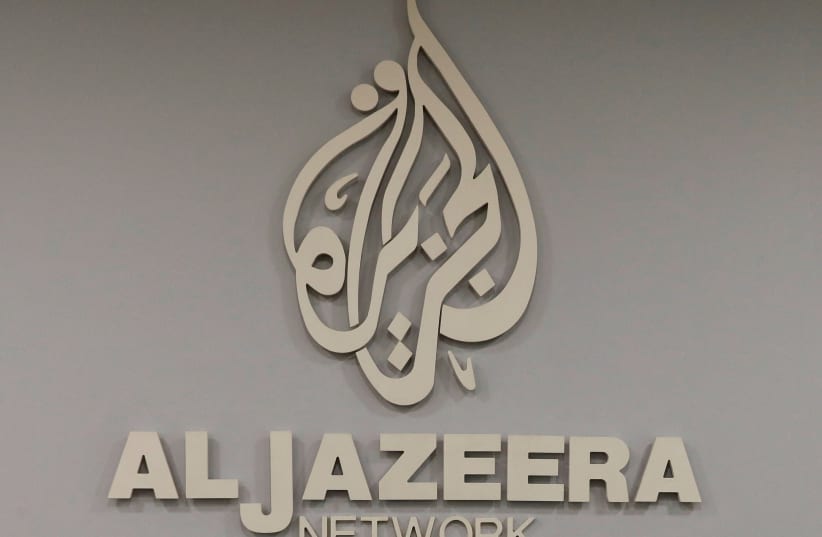  The logo of Qatar-based Al-Jazeera network is seen in one of their offices in Jerusalem  (photo credit: REUTERS/RONEN ZVULUN/FILE PHOTO)