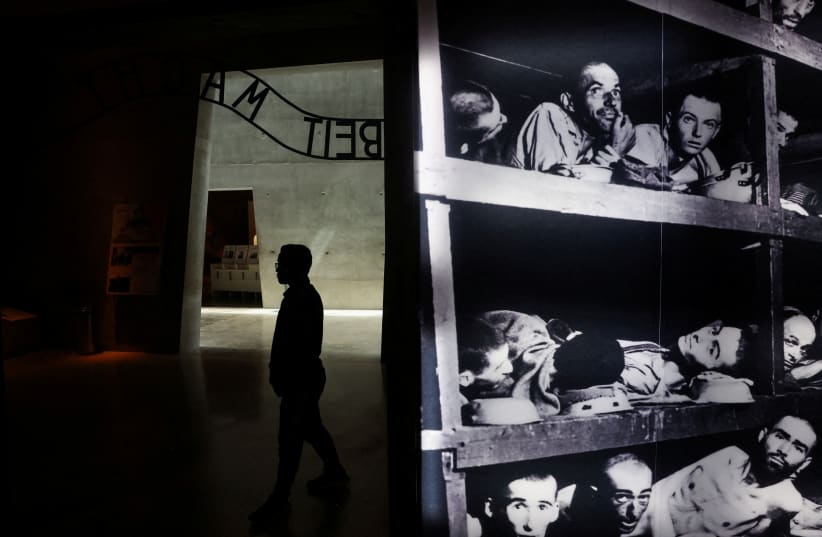  Visitors tour an exhibition ahead of Israel's national Holocaust memorial day, at Yad Vashem in Jerusalem (photo credit: REUTERS/Ronen Zvulun)