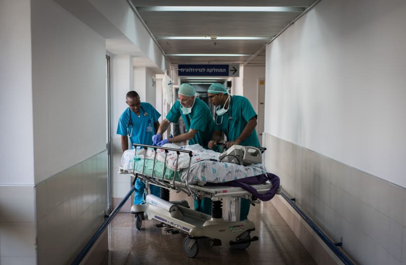 Doctors and nurses take two-year-old Zahran Khamis Haji to the emergency room for recovery after the infant underwent open-heart surgery at Wolfson Medical Center in Holon, Israel, on August 13, 2018. Uploaded on 6/5/2024 (photo credit: HADAS PARUSH/FLASH90)
