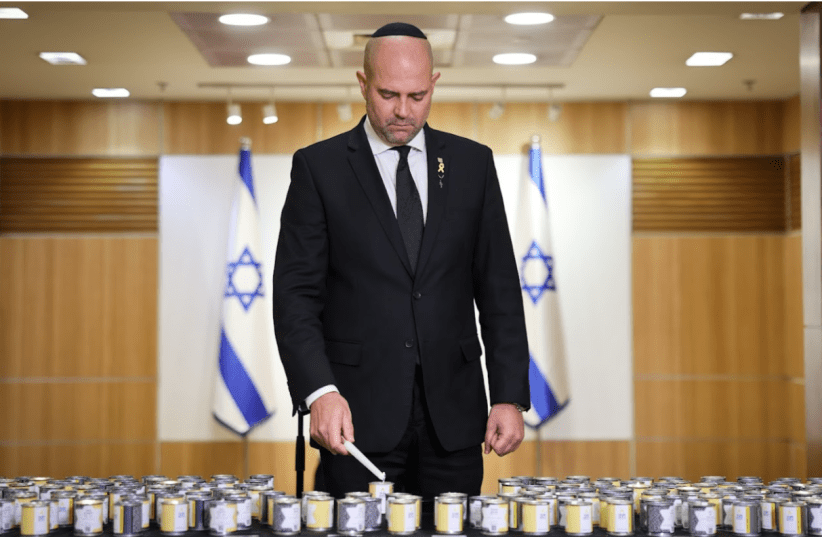 Knesset Speaker Amir Ohana lights a memorial candle in memory of Ada Dadosh, who was murdered in the Giado concentration camp in Libya. (photo credit: KNESSET)