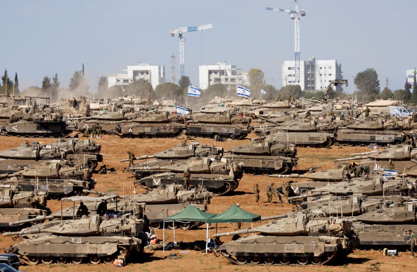  IDF soldiers gather next to tanks near the Israel-Gaza border, May 8, 2024 (photo credit: AMMAR AWAD/REUTERS)