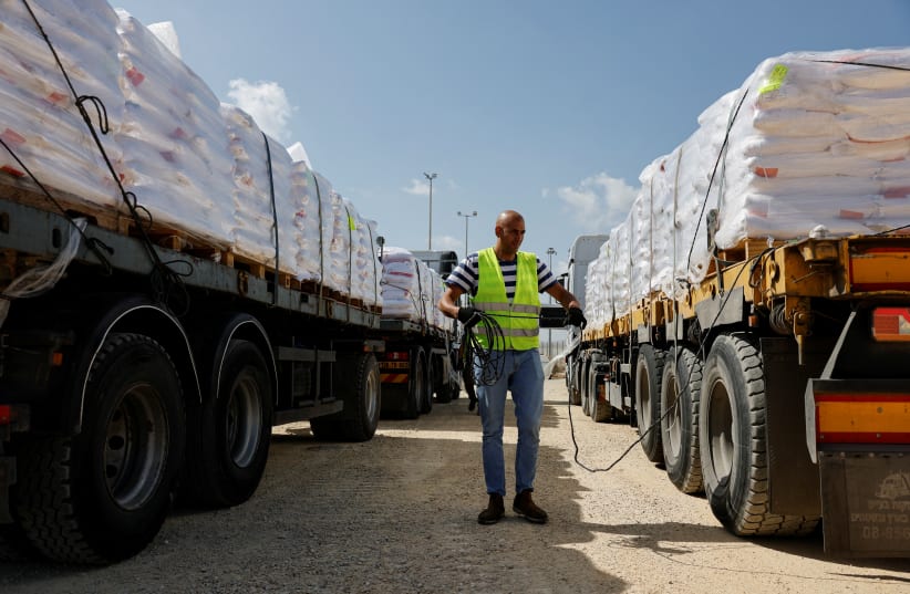  A person uses a rope on a truck with humanitarian aid meant for the Gaza Strip A person uses a rope on a truck with humanitarian aid meant for the Gaza Strip (photo credit: REUTERS/AMIR COHEN)