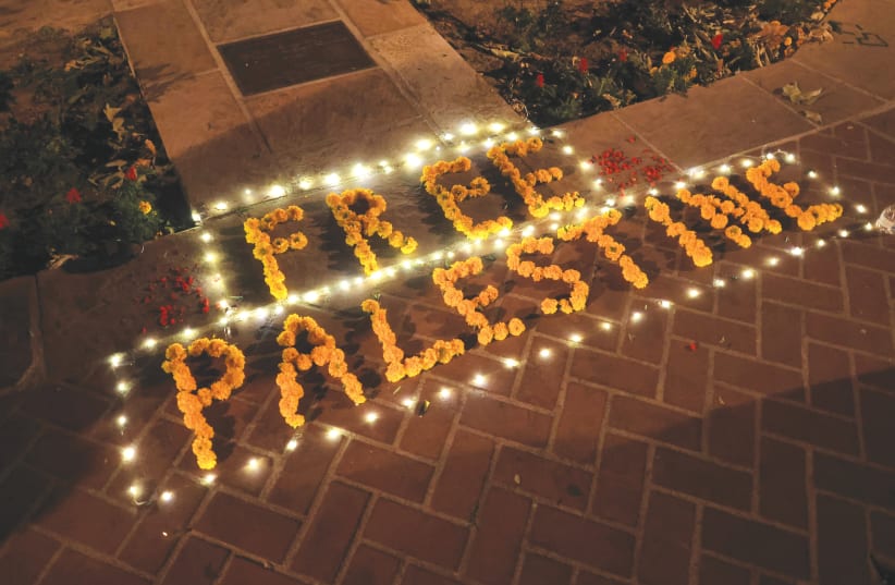  A FLOWER ARRANGEMENT that reads ‘Free Palestine’ is placed on the ground at USC, in Los Angeles during a protest in support of Palestinians in Gaza, last month. Can a free Palestine ever be truly free? The answer should be obvious, the writer asserts.  (photo credit: DAVID SWANSON/REUTERS)