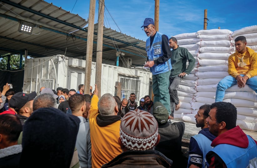  UNWRA STAFF distribute bags of flour in Khan Yunis, Nov. 22, 2023. (photo credit: ATIA MOHAMMED/FLASH90)