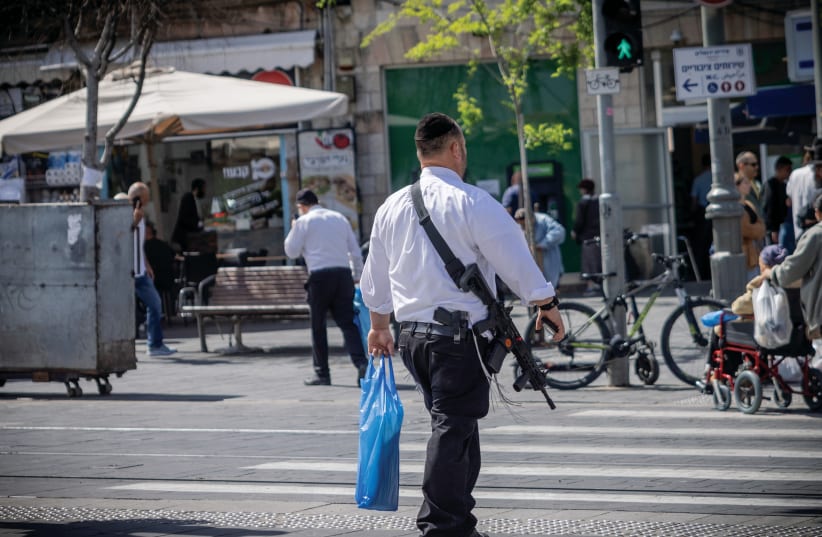  MOST INCREDIBLE honor: Reservist crosses a Jerusalem street. (photo credit: Chaim Goldberg/Flash90)