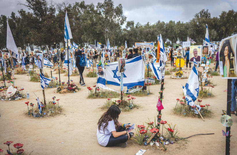 FAMILY MEMBERS visit the site of the Supernova music festival massacre in the Re’im Forest, six months after, on April 7. (photo credit: Chaim Goldberg/Flash90)