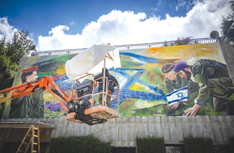  SOLDIERS paint a mural in Jerusalem last week ahead of Israel’s Remembrance Day on May 12-13. (photo credit: YONATAN SINDEL/FLASH90)