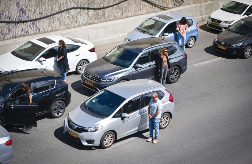  MOTORISTS STAND at attention, in Tel Aviv, as sirens sound across Israel to mark Holocaust Remembrance Day, last Monday. (photo credit: AVSHALOM SASSONI/FLASH90)