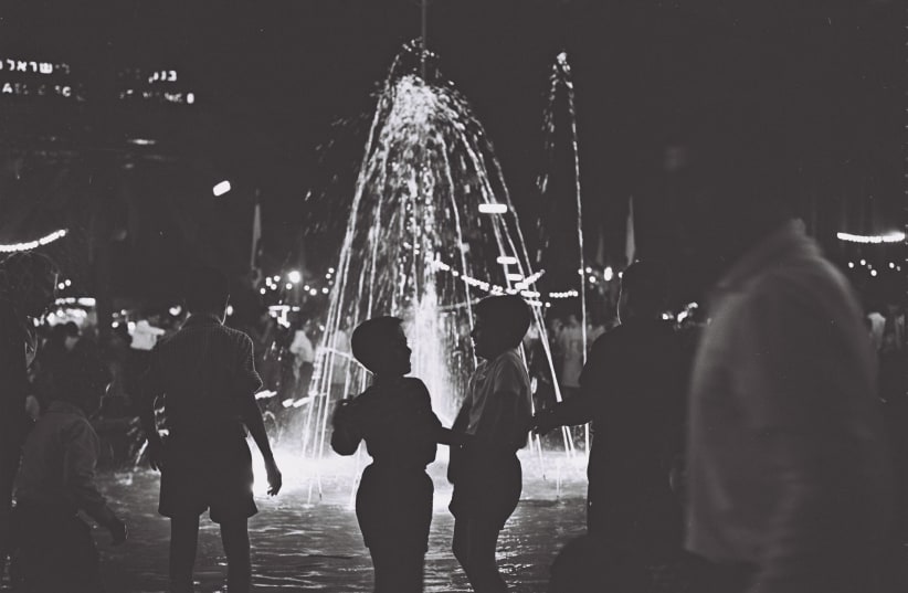 Tel Aviv children milling around the illuminated fountain in Dizengoff Square, on the eve of Independence Day 1966 (photo credit: Cohen Fritz/GPO)