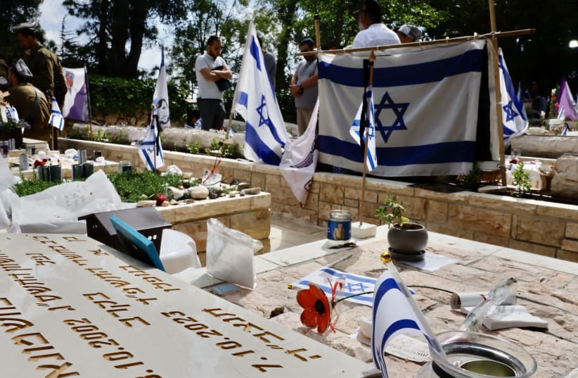 Bereaved Israelis seen at the Mount Herzl military cemetery, in Jerusalem, May 12, 2024 (photo credit: MARC ISRAEL SELLEM/THE JERUSALEM POST)