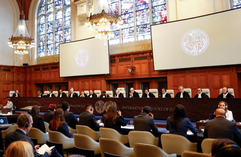  Judges and delegates sit in the courtroom during a public hearing at the International Court of Justice (ICJ) in The Hague, Netherlands, April 30, 2024.  (photo credit: REUTERS/PIROSCHKA VAN DE WOUW/FILE PHOTO)
