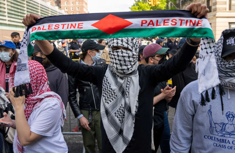 Protestors gather at the gates of Columbia University, in support of student protesters who barricaded themselves in Hamilton Hall, despite orders from university officials to disband or face suspension, during the ongoing conflict between Israel and the Palestinian Islamist group Hamas, in New York (photo credit: REUTERS/David Dee Delgado)