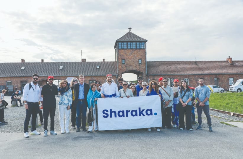  MEMBERS OF the Sharaka delegation stand near the entrance to Birkenau at the annual March of the Living on Holocaust Remembrance Day, last week. (photo credit: Sharaka)