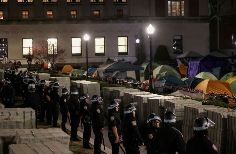  Police stand guard near an encampment of protesters supporting Palestinians on the grounds of Columbia University, during the ongoing conflict between Israel and the Palestinian Islamist group Hamas, in New York City, US, April 30, 2024. (photo credit: REUTERS/CAITLIN OCHS/FILE PHOTO)