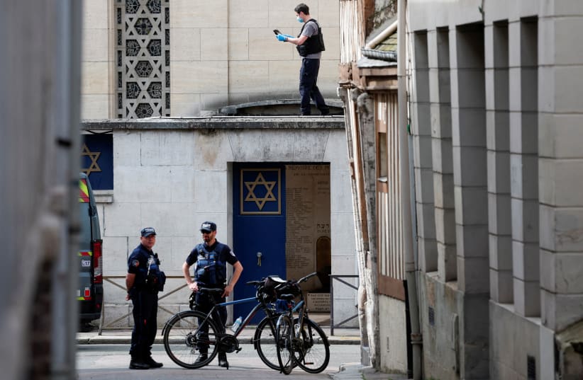  French police stand guard as a forensics member collects evidence after officers shot dead an armed man earlier who set fire to the city's synagogue in Rouen, France, May 17, 2024. (photo credit: REUTERS/GONZALO FUENTES)